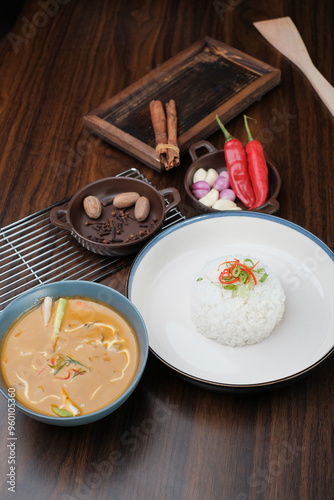 Curry Chicken Rice served in bowl isolated on wooded table top view and side view of Asian food photo