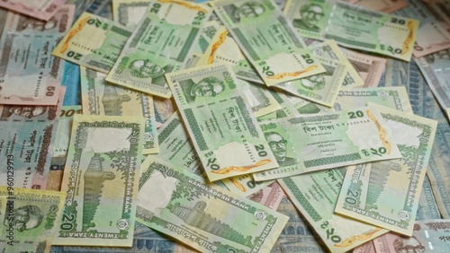 Bangladesh banknotes scattered showcasing various denominations of taka currency, highlighting the financial and economic culture of the country.