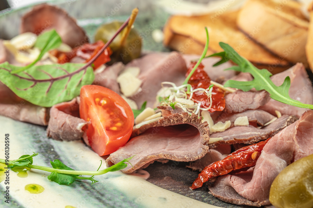 Pastrami slices, dried beef meat with vegetables and a delicate sauce, delicious antipasti