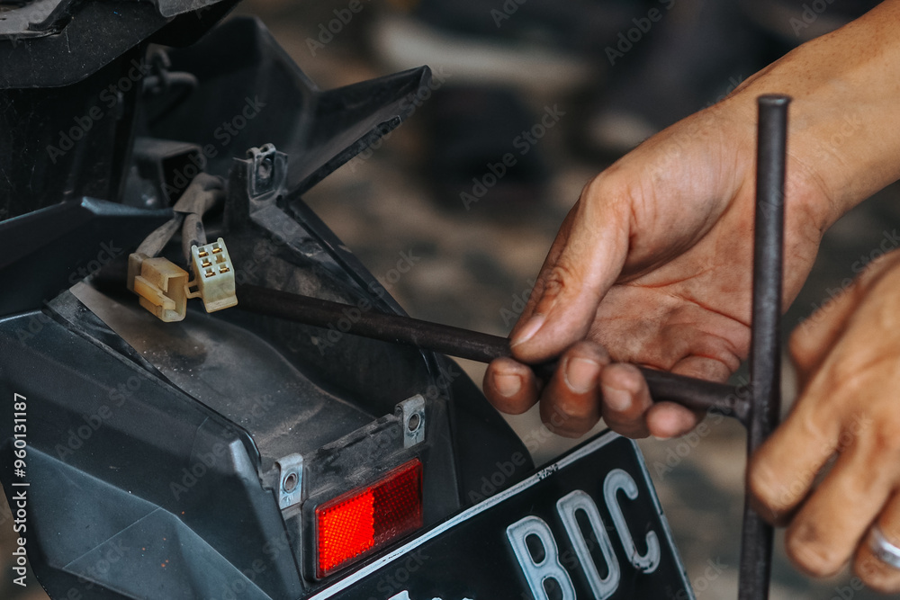 mechanic is servicing a motorbike, mechanic at work mechanic is servicing a motorbike, mechanic at work