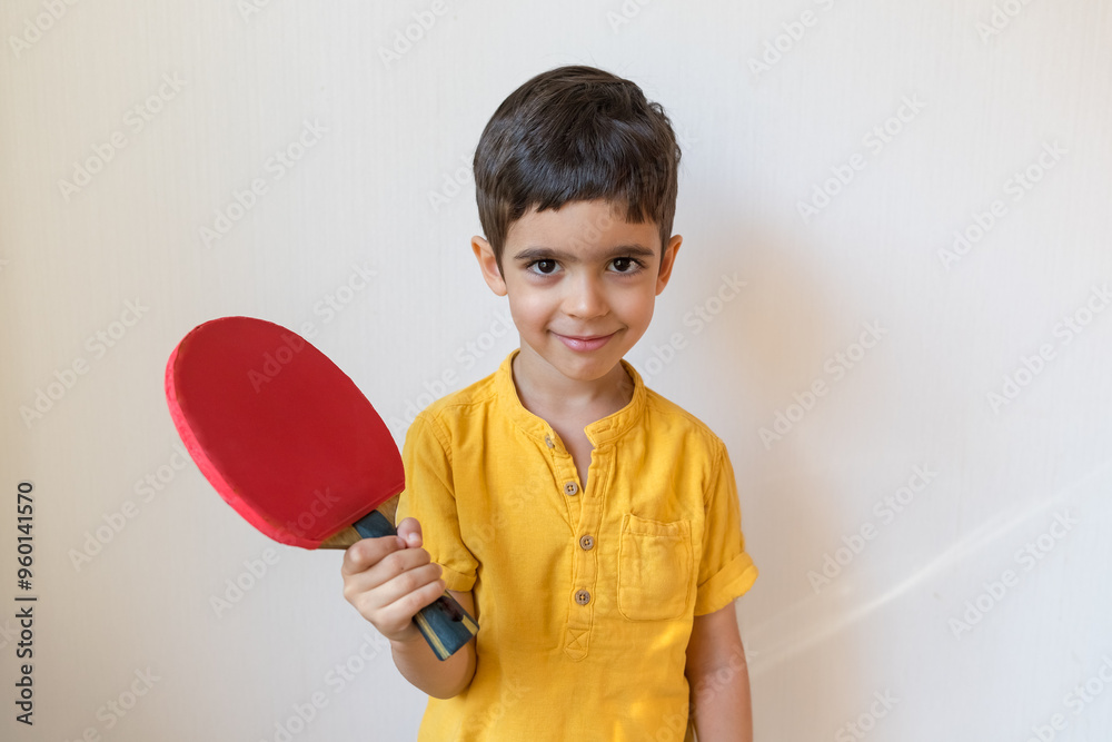 Boy plays ping pong isolated on white background. Child with table tennis racket. Sports concept Boy plays ping pong isolated on white background. Child with table tennis racket. Sports concept