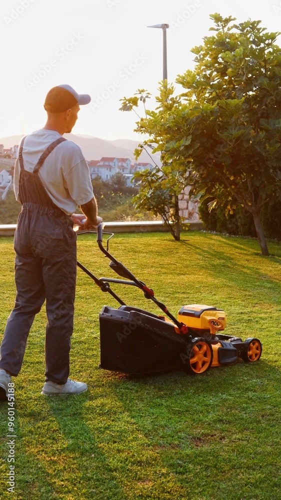 male gardener mowing lawn with lawn mower male gardener mowing lawn with lawn mower