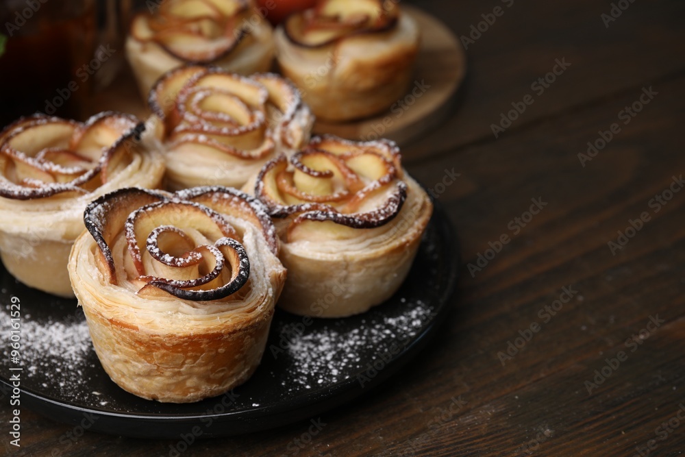 Freshly baked apple roses on wooden table, closeup Freshly baked apple roses on wooden table, closeup