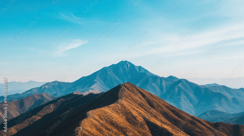 Fototapeta premium Majestic mountain vista, expansive clear blue sky, ideal for adventure, tranquil atmosphere, inviting exploration and outdoor activities, perfect for wanderlust seekers.