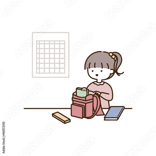 時間割を確認しながら忘れ物がないようにランドセルに持ち物を入れる小学生の女の子
