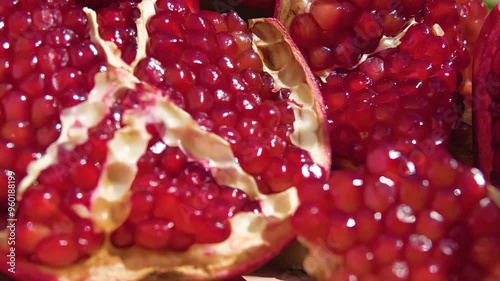 Juicy ripe pomegranate grains are falling down in slow motion. High quality 4k footage