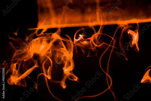 Illustration of orange beautiful smoke on the black background 