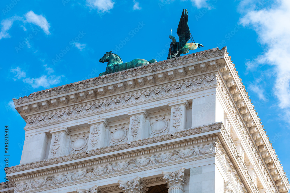 Sculpture on the top of Victorian Palace in Rome, Italy. Architecture features ornate details, asymmetrical shapes, elaborate trim, and a mixture of textures