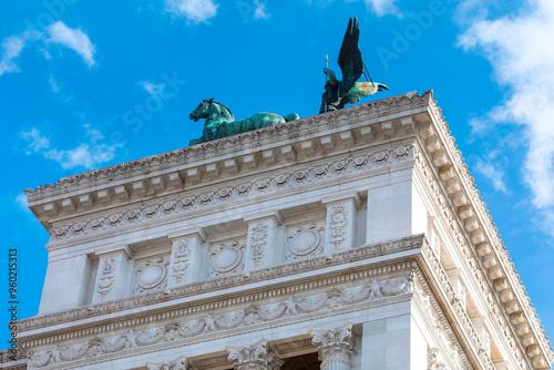 Sculpture on the top of Victorian Palace in Rome, Italy. Architecture features ornate details, asymmetrical shapes, elaborate trim, and a mixture of textures photo