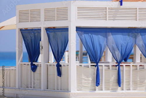 seaside resort beach with white sand and a gazebo for relaxation