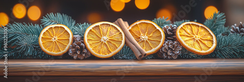 Natural elegance: dried oranges, pinecones, and cinnamon arranged with evergreen branches. The scene captures the earthy, comforting charm of the winter season.