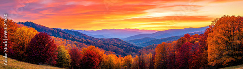 Breathtaking sunset over vibrant autumn landscape, with fiery oranges and reds illuminating trees and mountains. Natures beauty on full display.