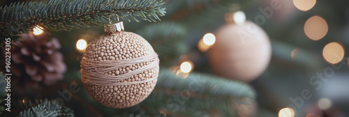 A minimalist Christmas bauble made of tiny wooden beads and rustic twine. The glowing lights in the background enhance the cozy, nature-inspired holiday decor.