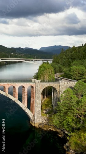 Vertical Cinematic aereal of Straumen Norway old and new bridges photo