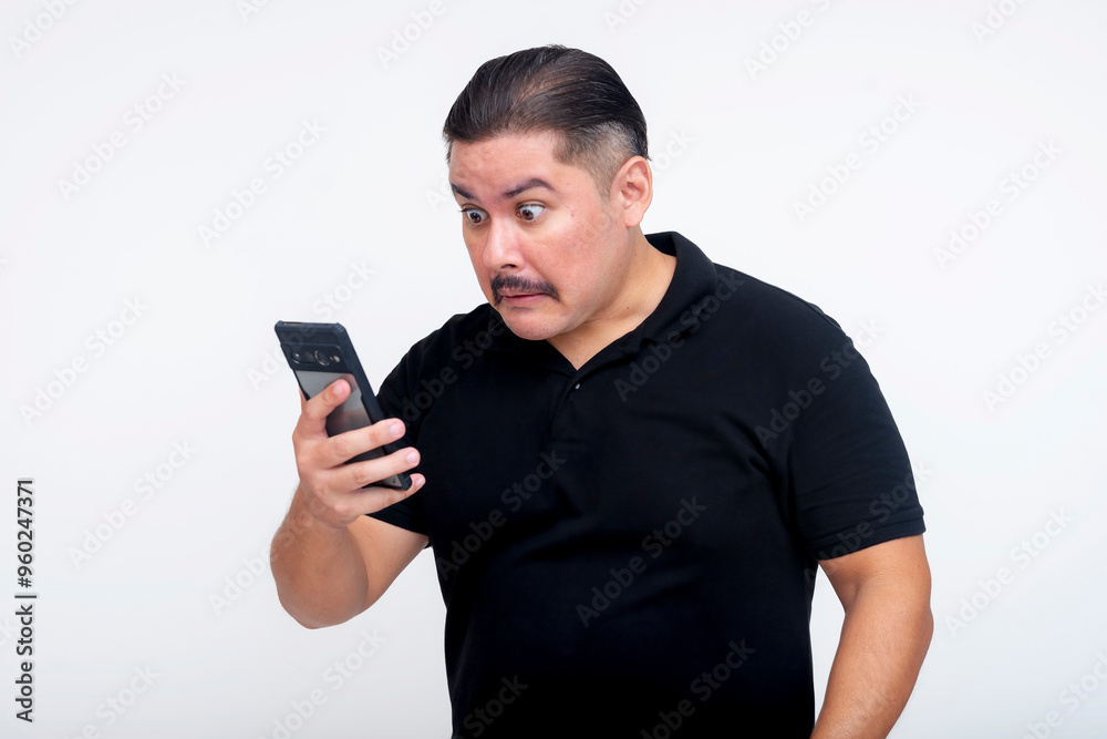 A middle aged man, while looking at his phone, stunned at controversial social media posts from a friend. Set against a white background. A middle aged man, while looking at his phone, stunned at controversial social media posts from a friend. Set against a white background.