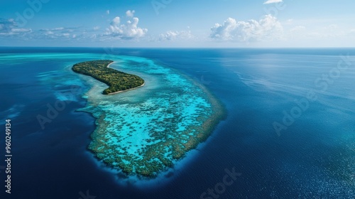 Aerial view of the Great Blue Hole and its surrounding coral atoll, with clear blue skies above.