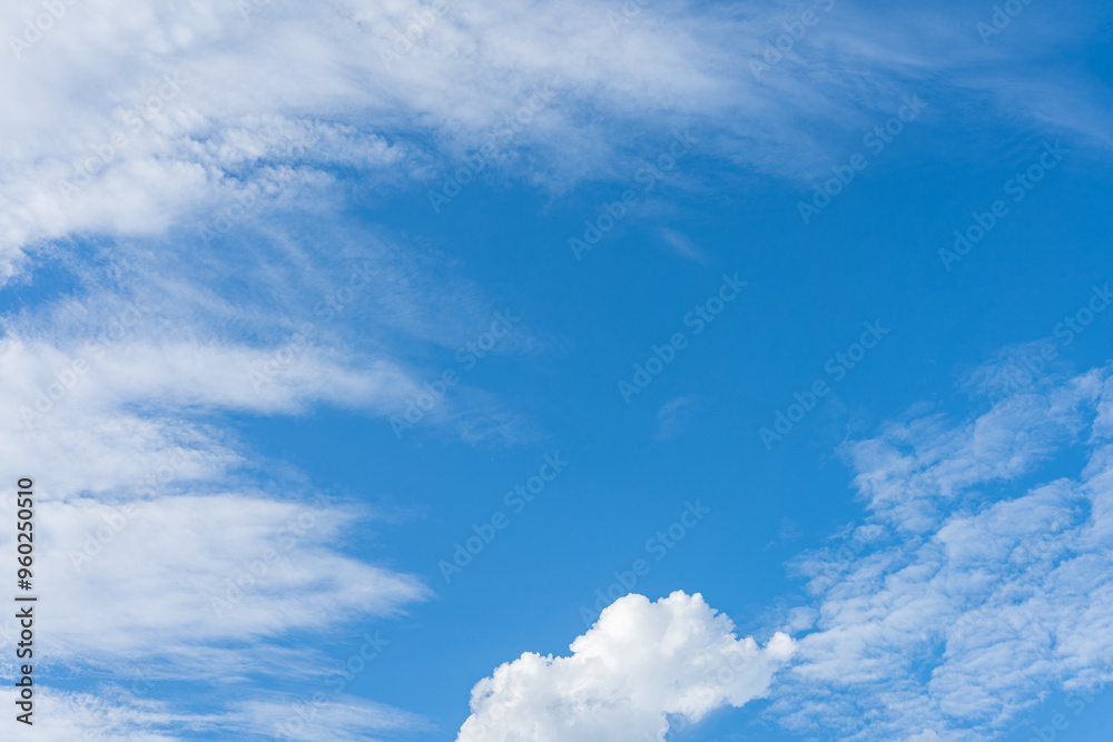 Fluffy white clouds drift across a vibrant blue sky, creating a breathtaking natural canvas Fluffy white clouds drift across a vibrant blue sky, creating a breathtaking natural canvas