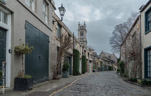 Perspective view of Circus Lane is a picturesque cobbled street in Stockbridge of Edinburgh, This residential street with pretty flower-covered terraced mews houses. Space for text, Selective focus.