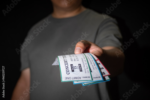 Close-up of a hand taking three tickets from a pocket,Ticket Scalping concept photo