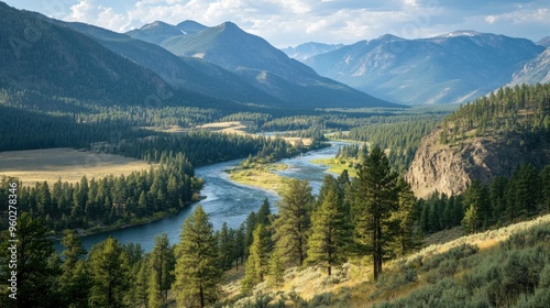 The picturesque Yellowstone River winding through a forested valley, with mountains in the background.