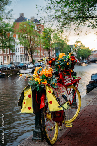 Amsterdam bicycle decorated in flowers next to canal