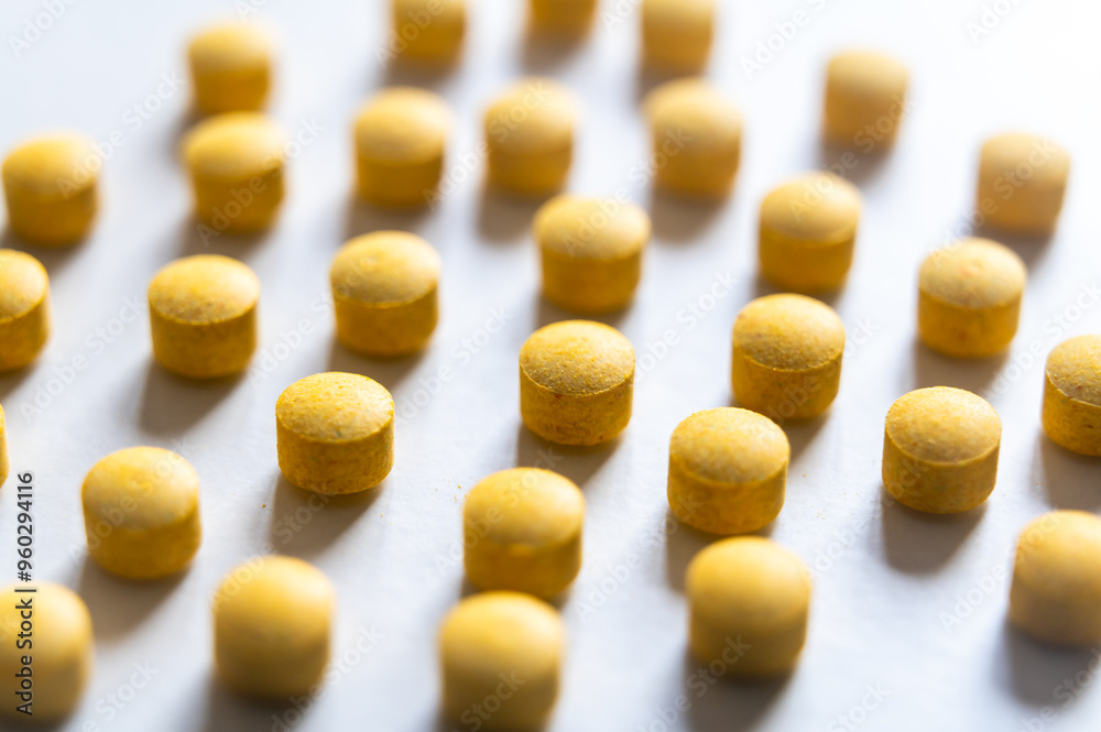 Medical tablets, placed next to each other on a white surface. Therapies, medicines and supplements. Medical tablets, placed next to each other on a white surface. Therapies, medicines and supplements.