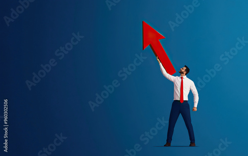 Businessman celebrating growth with an upward arrow, symbolizing success and achievement in a corporate environment.