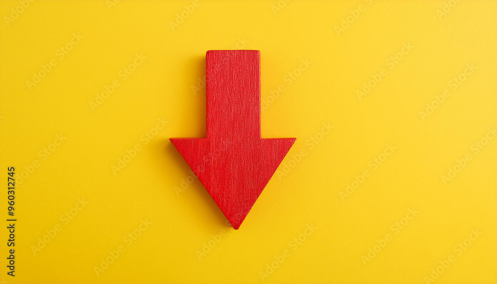 Red wooden arrow pointing down on yellow background. Business, market decline or economic Red wooden arrow pointing down on yellow background. Business, market decline or economic