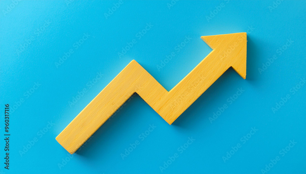 Yellow wooden arrow pointing upwards on blue background. Business and market growth concept Yellow wooden arrow pointing upwards on blue background. Business and market growth concept