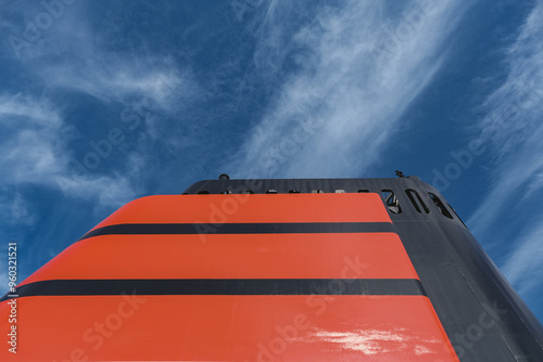 Red and black funnel smoke stack of legendary luxury ocean liner cruise ship against deep blue sky during cruise transatlantic passage in summer photo