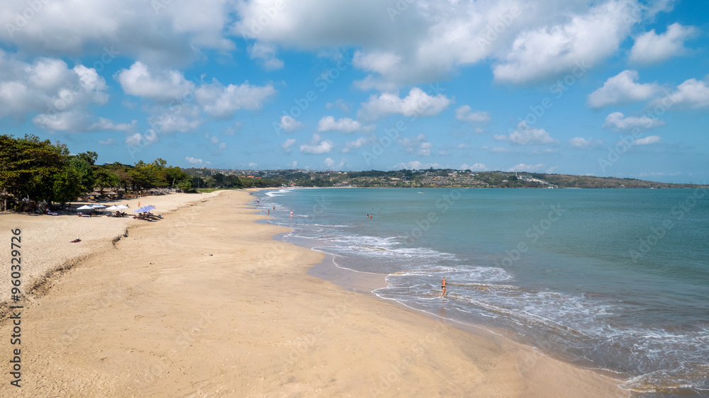 Aerial video on Jimbaran beach at Bali, Denpasar, Indonesia during a sunny day with calming sea waves.. Aerial video on Jimbaran beach at Bali, Denpasar, Indonesia during a sunny day with calming sea waves..