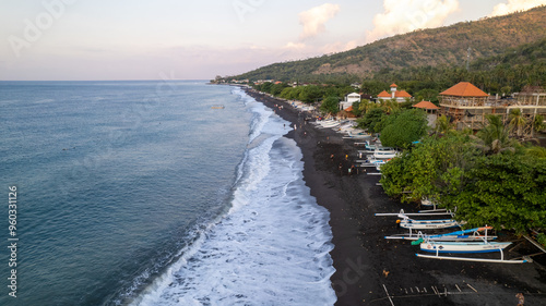 Black sand beach and traditional fishermen boats at the coast of Amed village, Karangasem district on tropical Bali island.