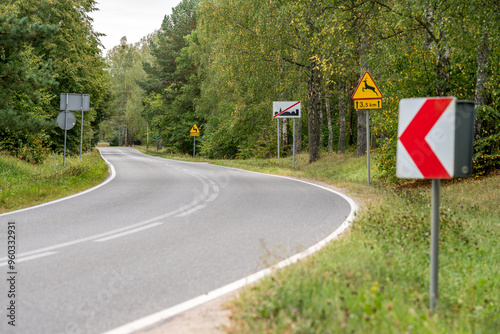 Fototapeta Naklejka Na Ścianę i Meble -  A sharp turn of an asphalt road in Masuria