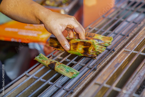 Otak otak is about to be moved from the grill and is still hot photo