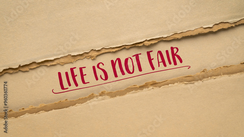Fotografie life is not fair - paper banner, recognition of the inherent inequalities, rando