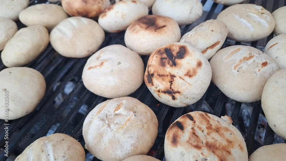 Traditional food of Bihar, Litti getting baked on a grill Traditional food of Bihar, Litti getting baked on a grill