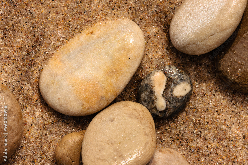Stones of various sizes align themselves along the sandy beach at at Kohler-Andrae State Park, Sheboygan, Wisconsin in late August Stones of various sizes align themselves along the sandy beach at at Kohler-Andrae State Park, Sheboygan, Wisconsin in late August