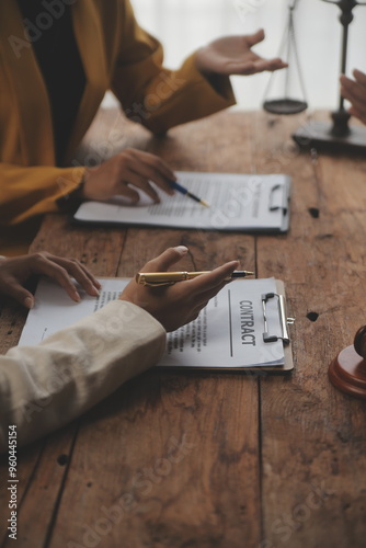 Photography Business and lawyers discussing contract papers with brass scale on desk in office