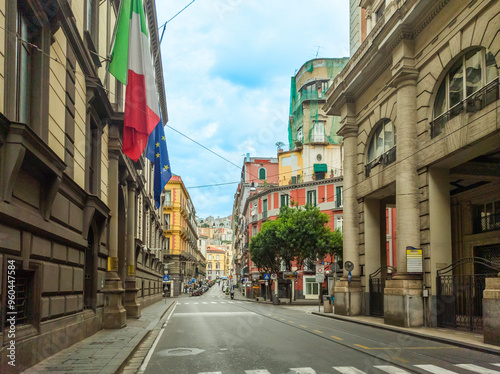 Elegant avenue in downtown Naples under a cloudy sky