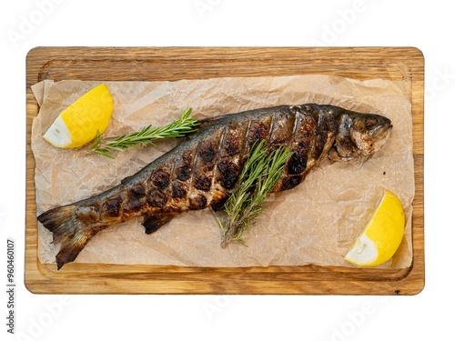 Gourmet Grilled Trout with Lemon and Rosemary on Rustic Wooden Board photo