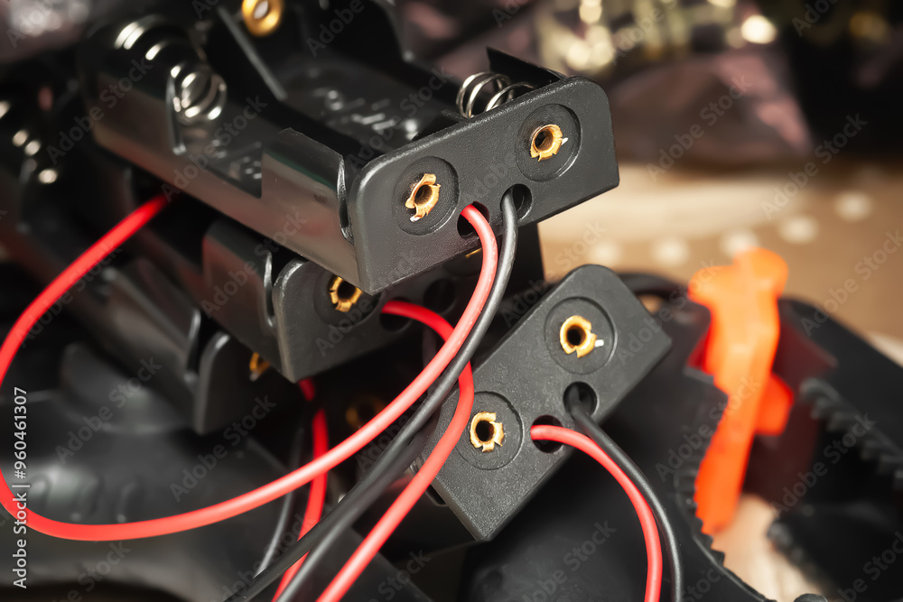 Obraz premium Battery holder. Plastic battery holder with wires and connectors close-up