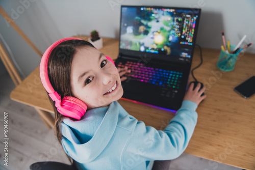 Top view photo of cheerful cute girl little gamer playing online video game indoors house photo