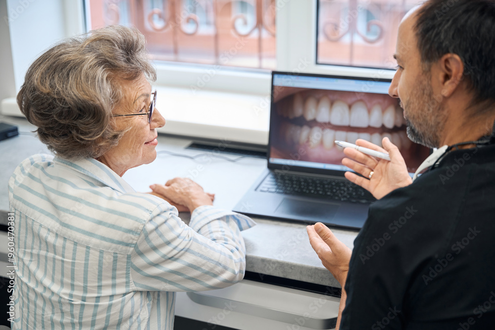 Doctor is talking to an elderly patient