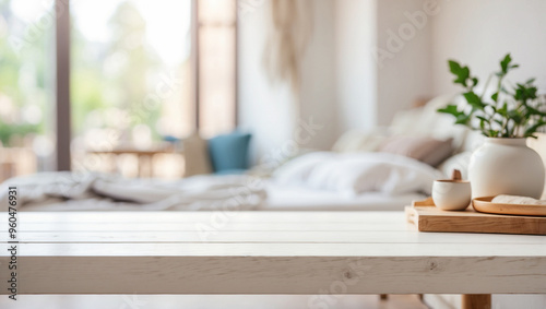The empty white wooden table top with blur background of bedroom interior. For product display