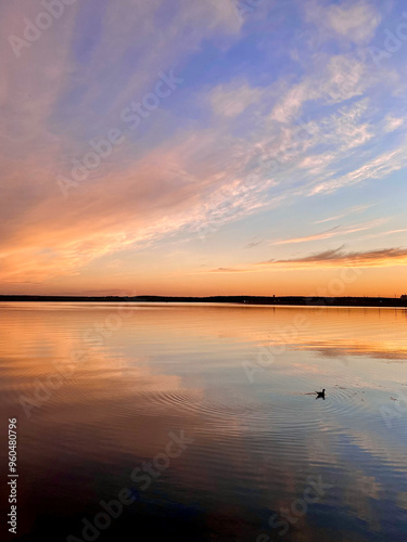 Beautiful sunset on the lake with clouds reflected in the water