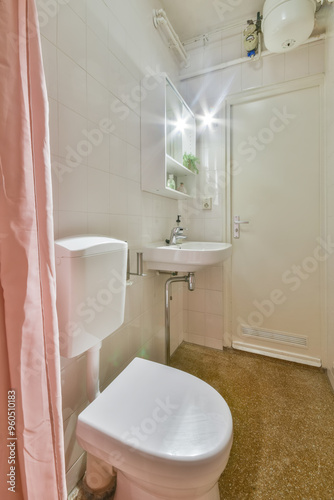 Compact modern bathroom with pink shower curtain photo