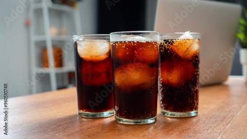 Double cool ice soft drink cola carbonated liquid fresh food with soda water, Cola drinking with ice in glass ready to refresh you, A cola soft drink is placed on the desk.