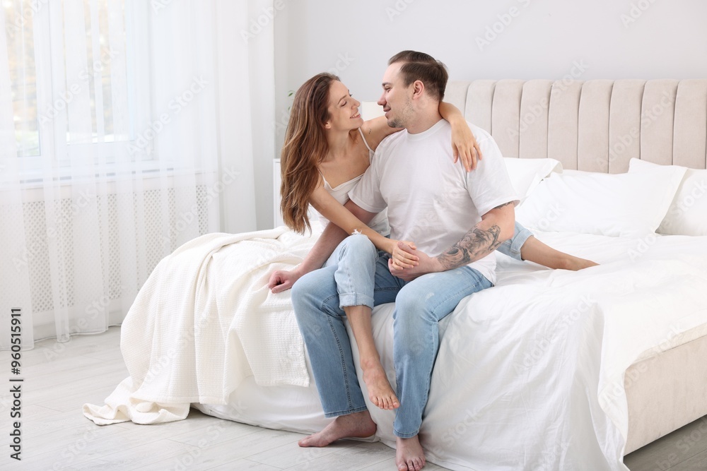 Happy couple spending time together on bed at home Happy couple spending time together on bed at home