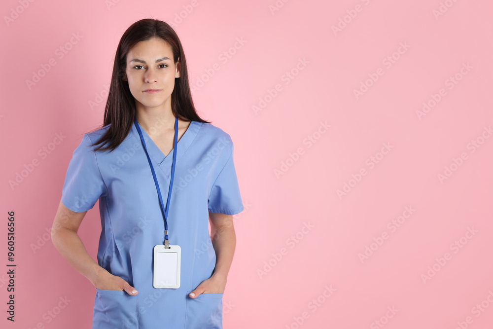 Beautiful nurse with badge on pink background. Space for text Beautiful nurse with badge on pink background. Space for text