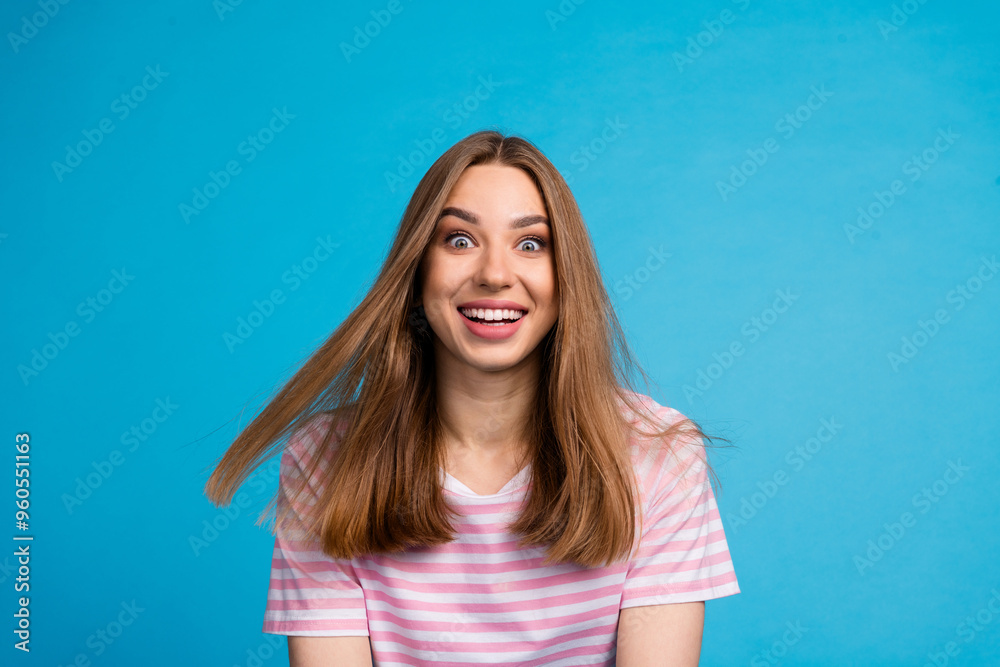 Photo portrait of glad optimistic cheerful woman wear stylish striped pink clothes isolated on blue color background Photo portrait of glad optimistic cheerful woman wear stylish striped pink clothes isolated on blue color background